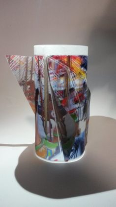 a coffee cup with an image of a sailboat on the bottom is shown in this photo