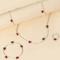 This Beautiful Jewelry Set Features A White Beaded Cherry Necklace, Bracelet, And Ring. The Set Is Perfect For Any And All Occasions. The Stretchy Ring (Measures Approx 1 Inch), And Stretchy Bracelet (Measures Approx 4 Inches) Ensures A Comfortable Fit For All. The Necklace Is Not Stretchy, Measures Approx 17 Inches And Has A 2 Inch Extender. There Is Also A Lobster Closure. The Round Beads Are The Main Attraction, With A Cherry Theme That Adds A Touch Of Sweetness To Any Outfit. Made In China, Bead Cherry, Beaded Cherry, Cherry Theme, Jewellery Summer, Beach Jewellery, Stretchy Rings, Cherry Necklace, Summer Jewellery, Bracelet And Ring