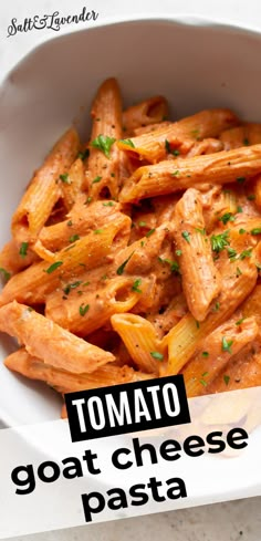 a white bowl filled with pasta covered in tomato sauce