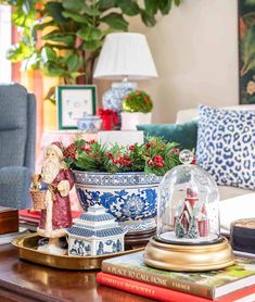 a living room filled with lots of furniture and christmas decorations on top of a coffee table