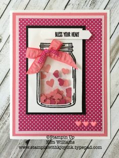 a handmade card with hearts in a mason jar and ribbon on the front,