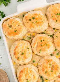 a casserole dish filled with biscuits and vegetables