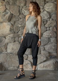 Indulge in the relaxed allure of our sheer rayon Drift Harem Pants--a harmonious blend of casual charm and sophistication. The sheer fabric drapes gracefully along the body, while the stretchy waistband ensures both comfort and style. Tapered cuffs add a touch of refinement, creating a casually charming silhouette. Complete with pockets, these harem pants seamlessly fuse comfort and versatility, making them a go-to choice for effortlessly chic and comfortable everyday wear. 100% Rayon Versatile Tapered Leg Harem Pants For Loungewear, Versatile Summer Harem Pants With Tapered Leg, Summer Versatile Tapered Leg Harem Pants, Versatile Harem Trousers For Loungewear, Versatile Stretch Ankle-length Harem Pants, Versatile Tapered Leg Bottoms For Yoga, Versatile Yoga Bottoms With Tapered Leg, Versatile Tapered Leg Yoga Bottoms, Versatile Yoga Pants With Tapered Leg