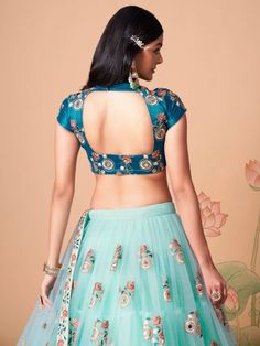 Wrapped up in the warmth of comfort and style, this pleasant sky blue color lehenga is formed with net material designed with mirror work, thread embroidery, and sequin work. This sky blue lehenga arrives with a sky blue color art silk material choli made with embroidery and mirror work. It also comes with a blue color net material dupatta created with thread embroidery and sequin work. This sky-blue lehenga is stitched and can be customized up to 42 inches. The choli will be fully stitched mate Fitted Anarkali Net Choli, Fitted Net Lehenga With Intricate Embroidery, Fitted Lehenga With Intricate Embroidery In Net, Fitted Net Choli With Intricate Embroidery, Traditional Fitted Net Choli, Embroidered Fitted Net Sets, Fitted Embroidered Net Saree, Embroidered Fitted Net Saree, Fitted Blue Sharara With Floral Embroidery