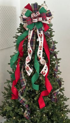 a christmas tree decorated with ribbons and bows