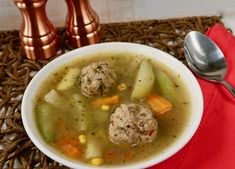 a bowl of soup with meatballs and vegetables