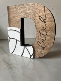 the letter d is made out of wood and marble