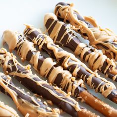 chocolate covered pretzels with peanut butter drizzled on them