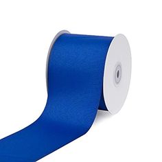 a roll of royal blue satin ribbon on a white background with an adhesive tape