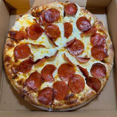 a pepperoni pizza in a cardboard box