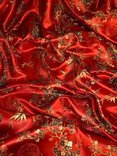 red silk with gold and black flowers on it