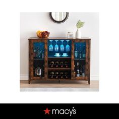 a wooden cabinet with glass doors and shelves filled with wine bottles on top of it