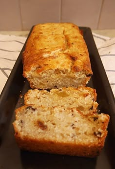 two slices of banana bread on a black tray