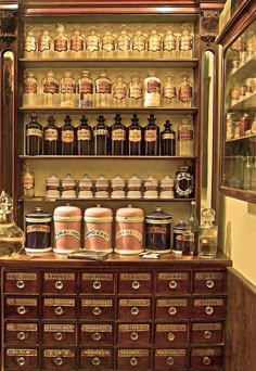 an old wooden cabinet filled with lots of jars