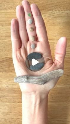 a person's hand is holding rocks in the shape of a video game controller