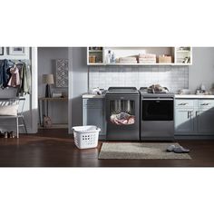 an image of a laundry room setting with clothes on the dryer and washing machine