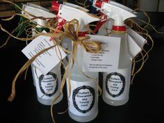 three bottles with labels and twine tied to them sitting on a black counter top