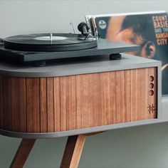 an old record player is sitting on top of a table