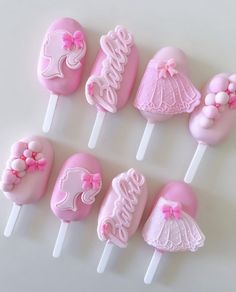 there are many pink cake pops on the table