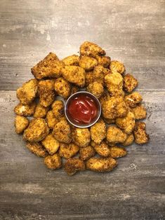 fried chicken nuggets with ketchup on a wooden table