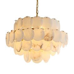 a white chandelier hanging from a gold chain with lights on each end and round shells in the middle