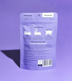 a bag of dog treats sitting on top of a purple table next to a white wall