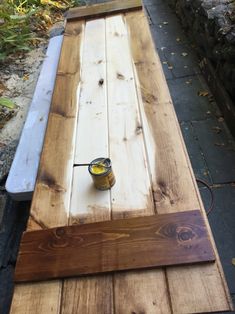 a table made out of pallet wood with a jar of mustard on top and a bottle of oil in the middle