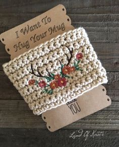 two crocheted coasters sitting on top of a wooden table next to each other