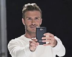 a man is taking a selfie with his cell phone in front of the camera