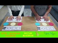 two children are playing with paper shapes on a table