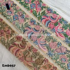 three pieces of embroidered fabric with flowers and leaves on them, all in different colors