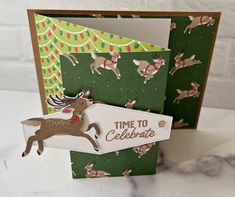 a close up of a greeting card with reindeers and christmas lights on it,