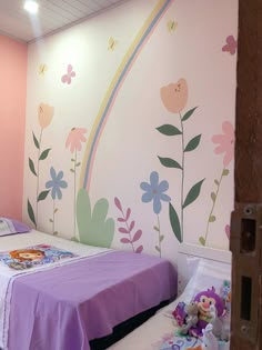 a child's bedroom decorated in pastel colors with flowers and butterflies on the wall