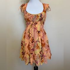 Brand New With Tags $128 Retail Free People Movement Floral Print Smocked Bodice Mini Dress In Orange Womens Size Xs Pit To Pit 15” Length 31” Please See All Photos For More Details And Measurements Multicolor Smocked Dress With Square Neck For Summer, Bohemian Ruched Mini Dress For The Beach, Bohemian Fitted Mini Dress With Smocked Back, Casual Multicolor Mini Length Smocked Dress, Yellow Smocked Fitted Dress, Casual Multicolor Mini Smocked Dress, Fitted Multicolor Smocked Sundress, Fitted Bohemian Mini Dress With Smocked Back, Yellow Fitted Smock Dress