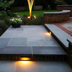 an outdoor patio with lights and plants in the background