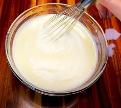 someone is whisking cream in a bowl