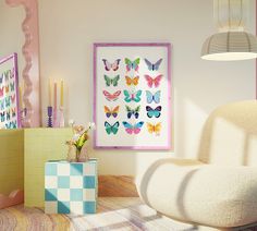 a living room filled with furniture and paintings on the wall next to a chair in front of a window