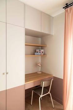 a room with a desk and shelves in it