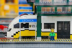 a lego train station with a man standing next to it