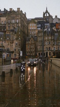 cars are parked on the street in the rain