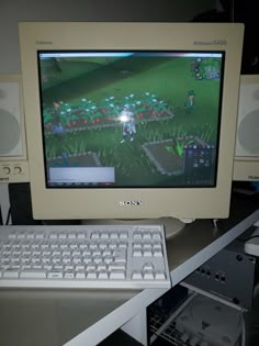 a computer monitor sitting on top of a desk next to two keyboards and mouses