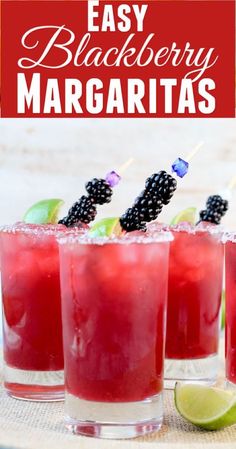 three glasses filled with blackberry margaritas on top of a table