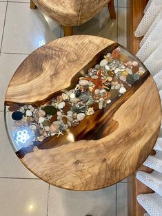 a wooden table topped with lots of rocks and pebbles on top of a tiled floor