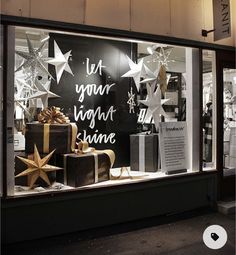 a store window with christmas decorations and presents in it