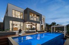 a large house with a pool in front of it