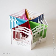 an open book with cut out paper on it