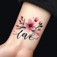 a woman's wrist tattoo with pink flowers and the word love written on it