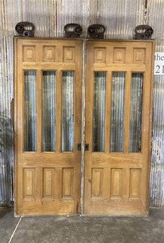 two wooden double doors sitting next to each other