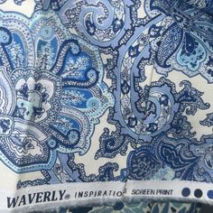 closeup of the blue and white paisley print on this shirt is worn by someone