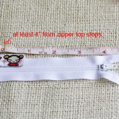 a measuring tape with an image of a monkey on it and the words at least 4 from zipper top stops